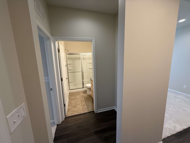 hallway with dark hardwood / wood-style flooring