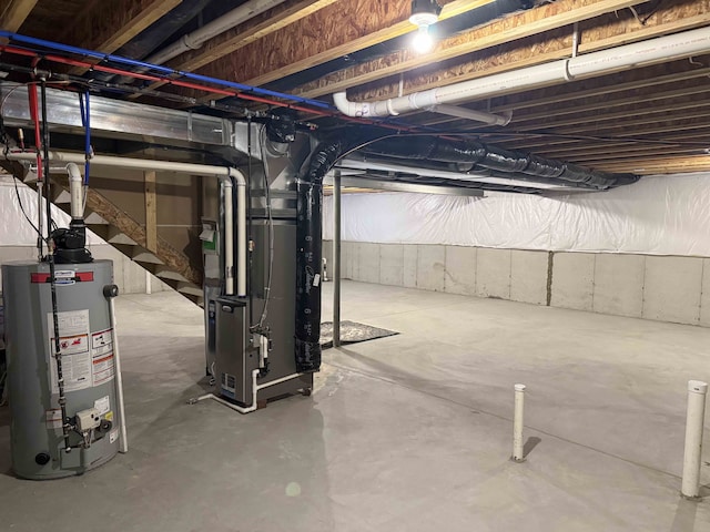 basement featuring heating unit and water heater