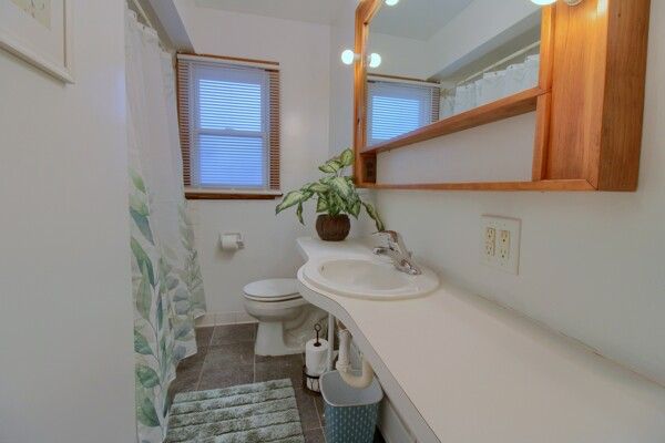 bathroom featuring sink, tile patterned flooring, and toilet