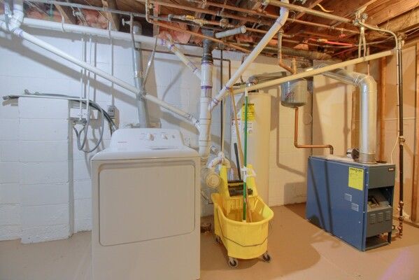 washroom featuring washer / clothes dryer and water heater