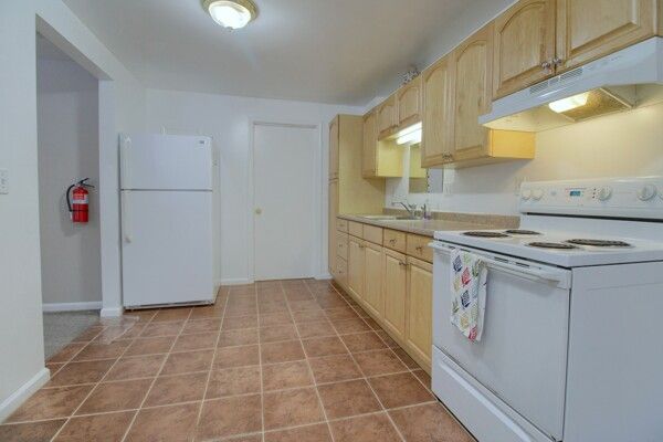 kitchen featuring white appliances, sink, and light brown cabinets