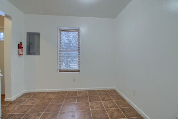 tiled spare room with electric panel