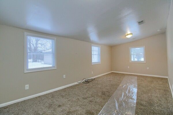 spare room with lofted ceiling and carpet flooring