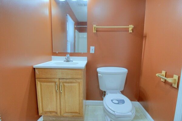 bathroom featuring toilet and vanity