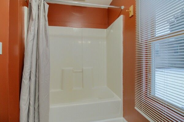 bathroom with a wealth of natural light and shower / bath combo