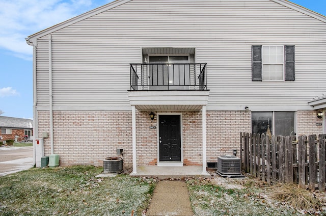 view of front of house with a balcony and central AC unit