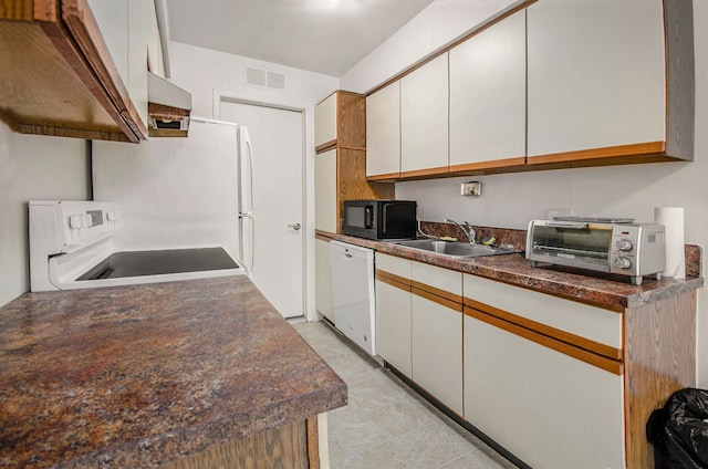 kitchen featuring range, white cabinets, dishwasher, and sink