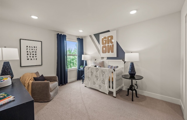 carpeted bedroom with a crib