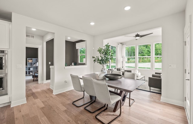 dining space featuring ceiling fan and light wood-type flooring