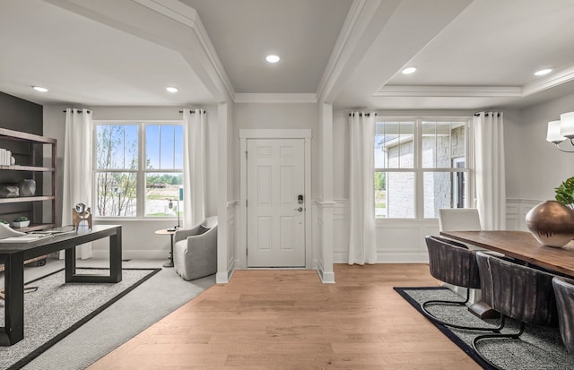 office with a healthy amount of sunlight, light hardwood / wood-style floors, and ornamental molding