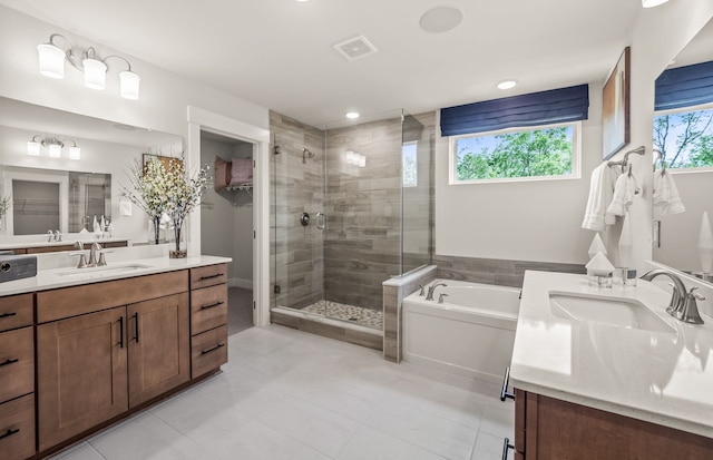 bathroom featuring tile patterned floors, vanity, and plus walk in shower