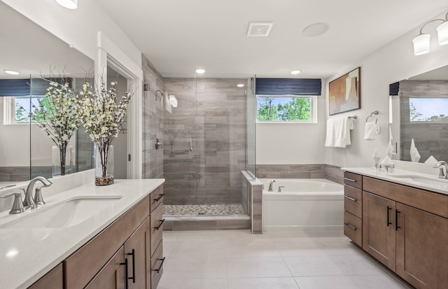 bathroom featuring separate shower and tub, tile patterned flooring, and vanity