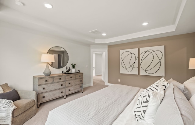 carpeted bedroom featuring a raised ceiling