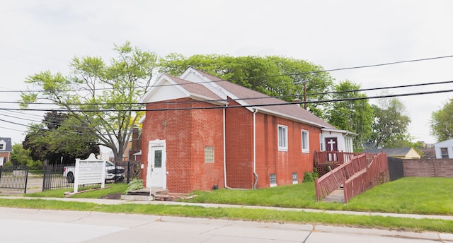 view of side of home with a yard