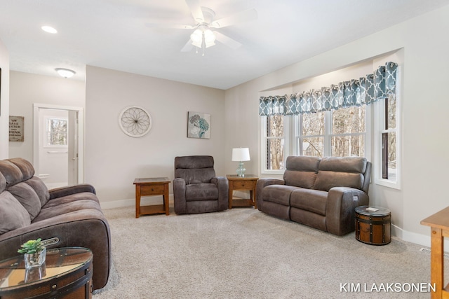 carpeted living room featuring ceiling fan