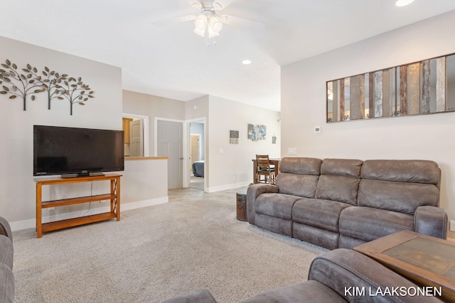 carpeted living room featuring ceiling fan