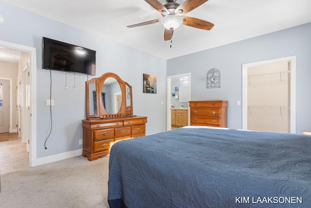 carpeted bedroom with a walk in closet, ceiling fan, a closet, and ensuite bathroom