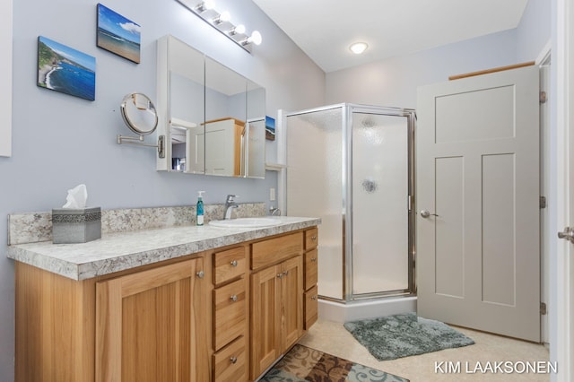 bathroom featuring vanity and an enclosed shower