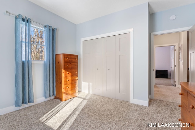 unfurnished bedroom featuring light carpet and a closet