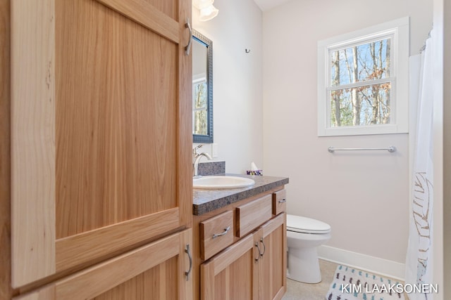 bathroom featuring toilet, vanity, and tile patterned floors