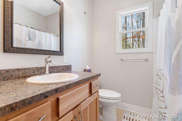 bathroom with tile patterned floors, vanity, and toilet