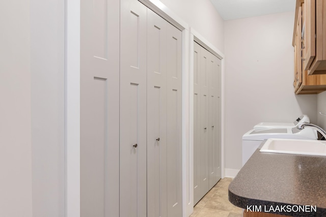 laundry room with cabinets and sink