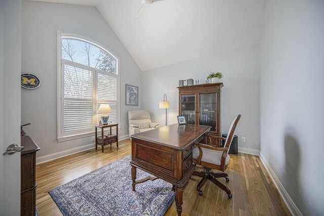 office space featuring hardwood / wood-style floors and vaulted ceiling