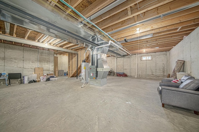 basement featuring heating unit and water heater