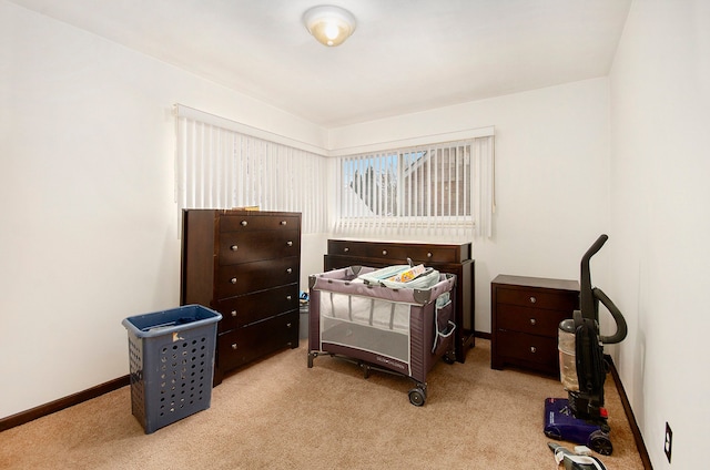 bedroom featuring light carpet