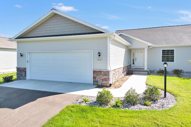 single story home with a garage and a front lawn