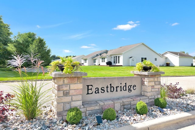 community / neighborhood sign featuring a lawn