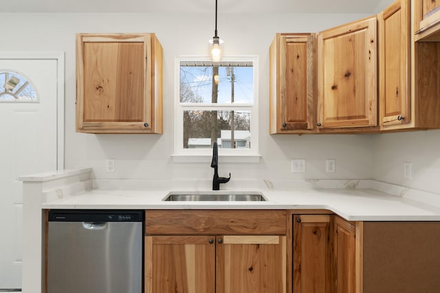 kitchen with dishwasher, decorative light fixtures, and sink