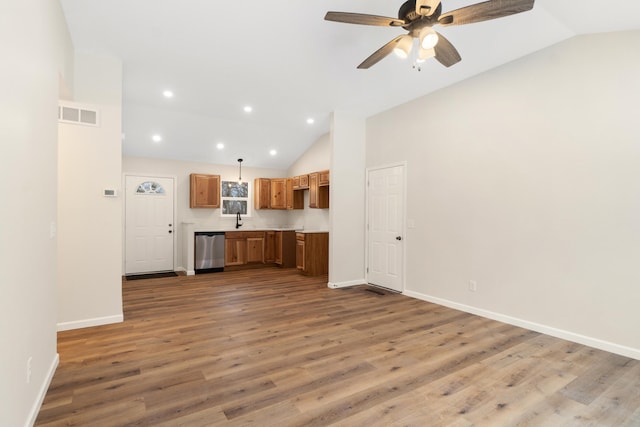 unfurnished living room with ceiling fan, sink, high vaulted ceiling, and hardwood / wood-style flooring