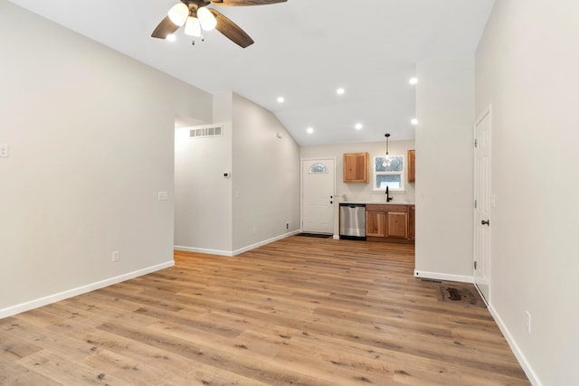 unfurnished living room featuring ceiling fan, light wood-type flooring, sink, and lofted ceiling