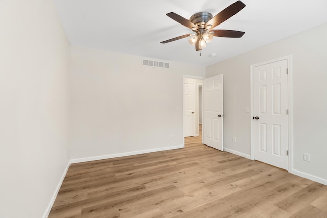 interior space featuring visible vents, a ceiling fan, light wood-style flooring, and baseboards