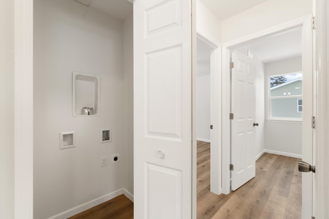 clothes washing area featuring light wood-type flooring, laundry area, washer hookup, and hookup for an electric dryer