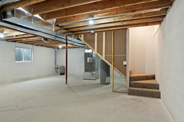 below grade area featuring stairway and heating unit