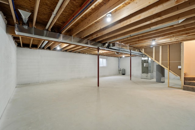 basement featuring stairway and heating unit