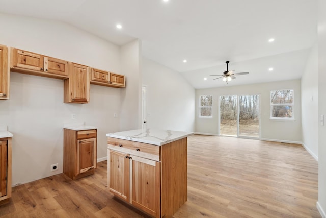 kitchen featuring lofted ceiling, light wood finished floors, and recessed lighting