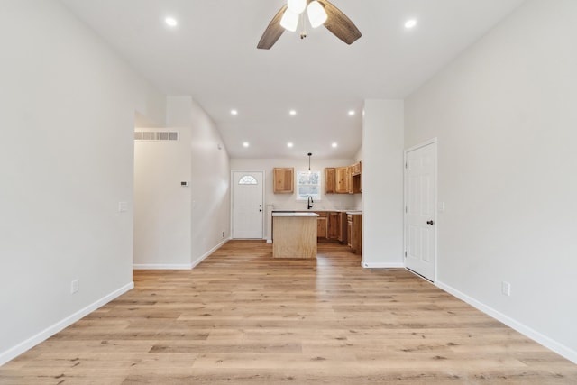 unfurnished living room featuring vaulted ceiling, light wood-style flooring, visible vents, and recessed lighting