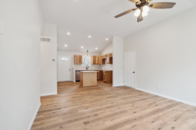 unfurnished living room featuring a ceiling fan, baseboards, vaulted ceiling, visible vents, and light wood-style floors