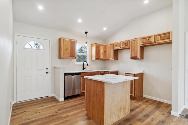 kitchen featuring a center island, dishwasher, light wood-style flooring, and a sink