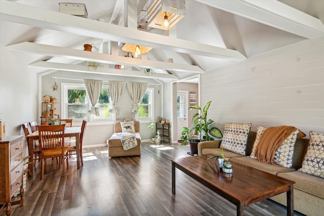 living room featuring dark wood-type flooring and vaulted ceiling with beams