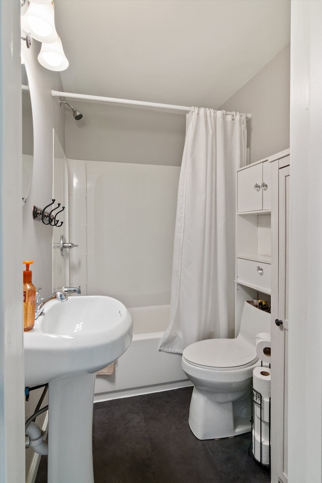 bathroom featuring toilet and shower / tub combo with curtain