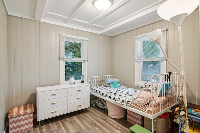 bedroom featuring wood walls and dark hardwood / wood-style floors