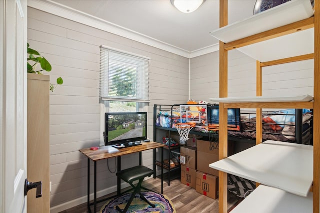 office featuring hardwood / wood-style floors, crown molding, and wooden walls