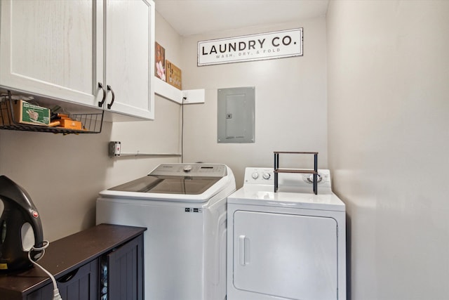 laundry room featuring cabinets, electric panel, and independent washer and dryer