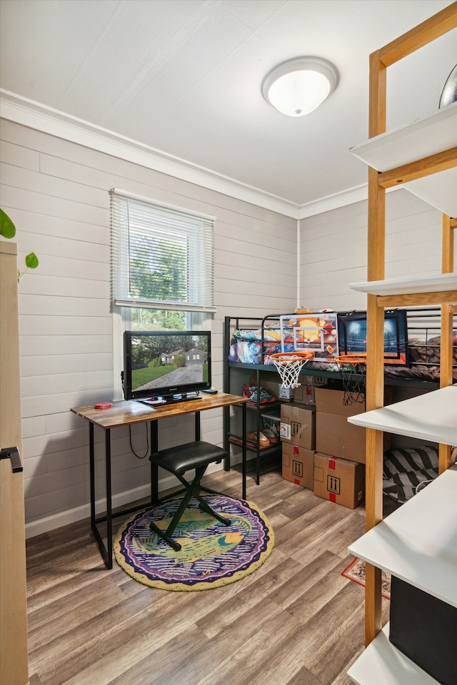 office featuring wood walls, hardwood / wood-style floors, and ornamental molding