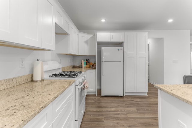 kitchen featuring light hardwood / wood-style floors, white cabinetry, light stone counters, and white appliances