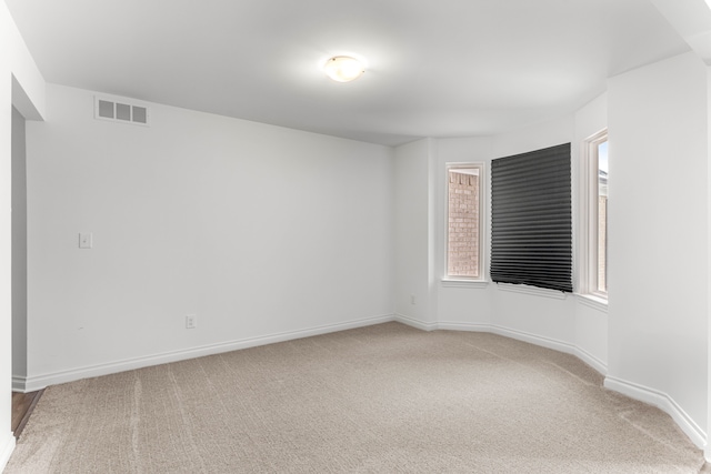 carpeted spare room featuring a wealth of natural light